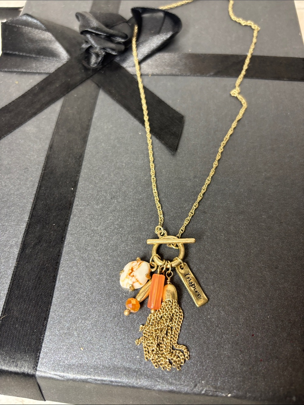 Inspire Gold-Tone 18” Toggle Necklace with Orange Tassel & Bead Charms